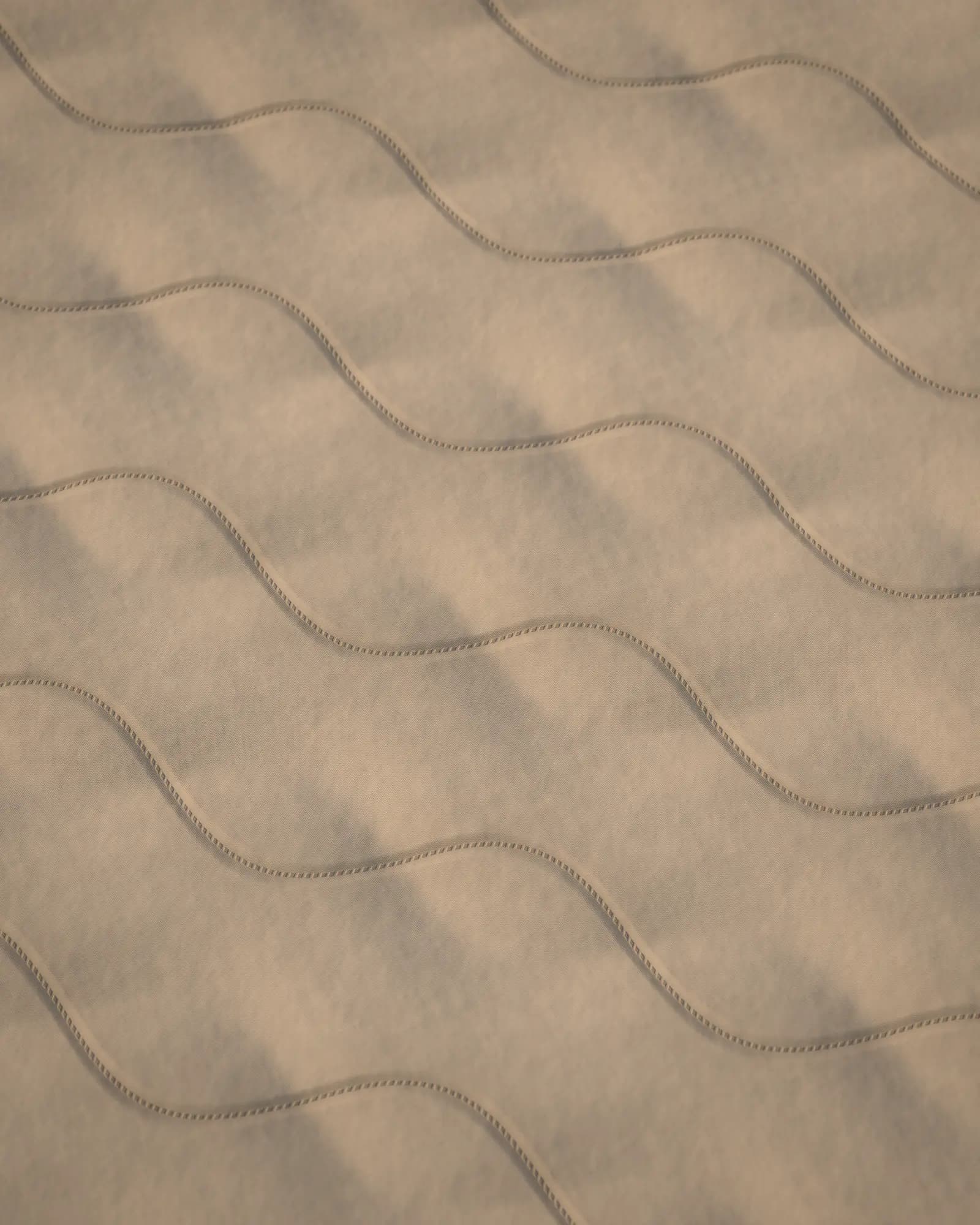 Illustration: close-up of a foam mattress's cover, edge and bedding — rendered artwork, not a product photo